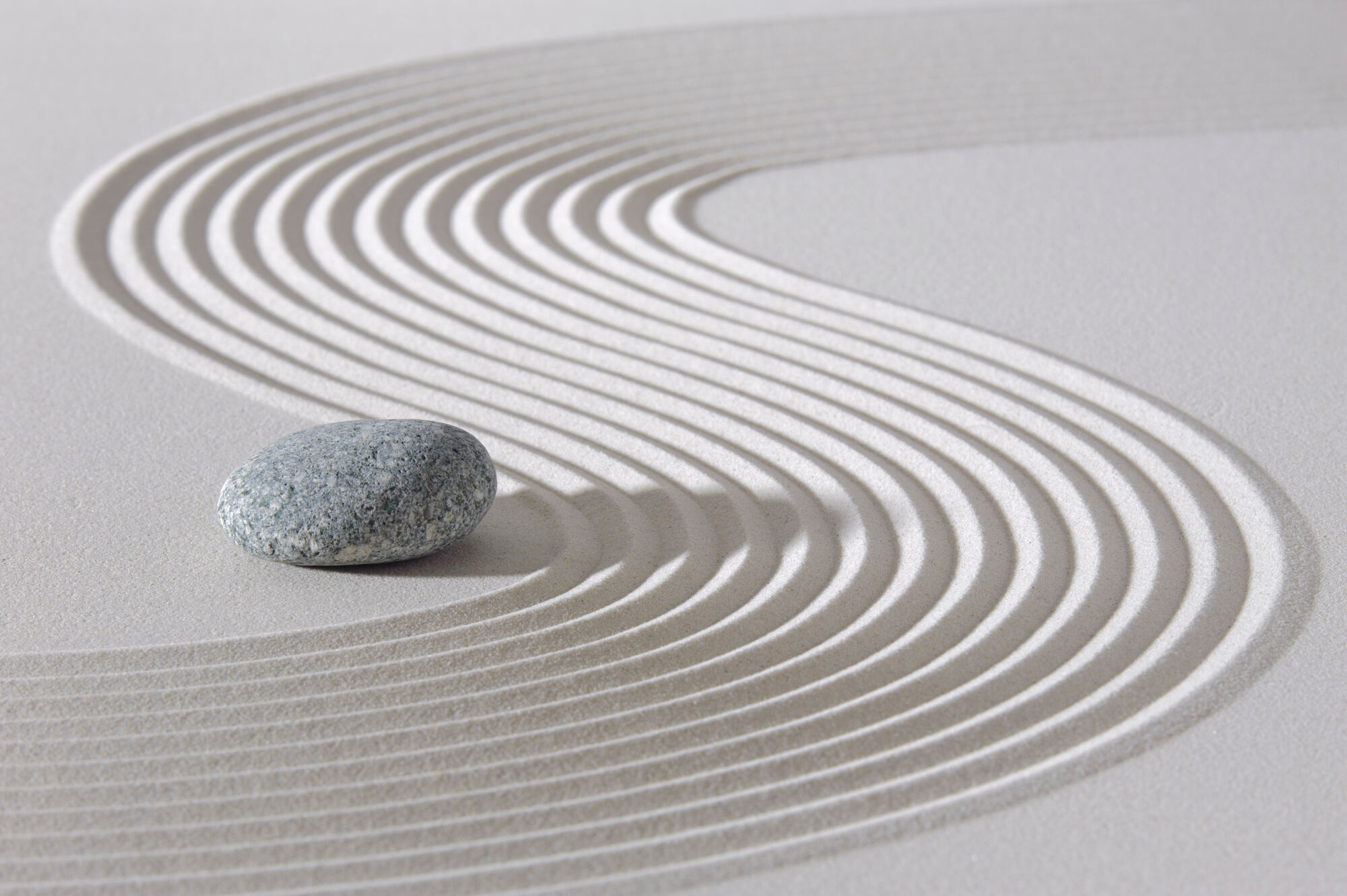 Balanced stack of smooth stones on the shore